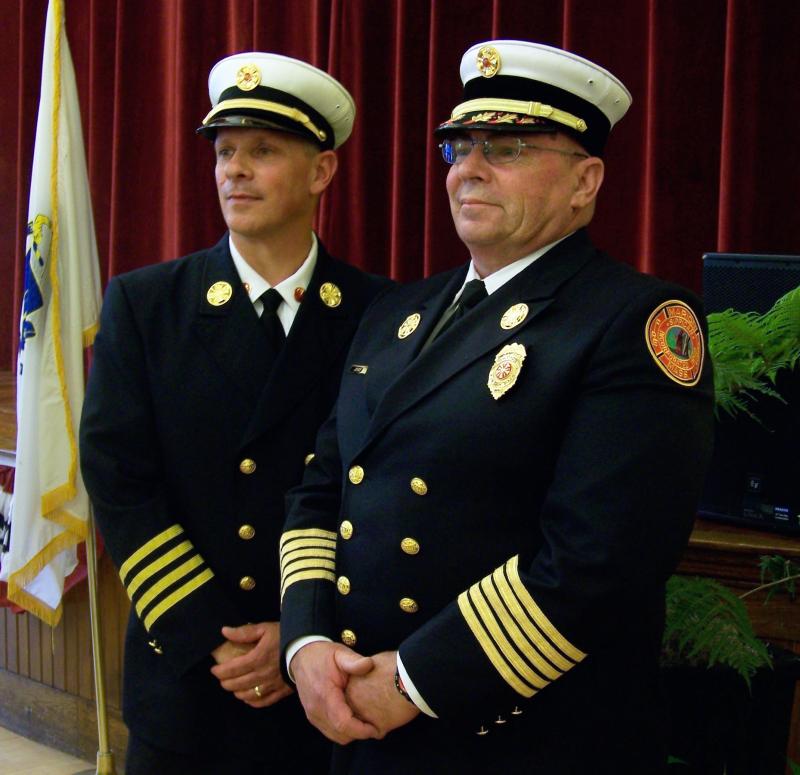 Marion’s new Fire Chief Brian Jackvony, left, stands with his predecessor Chief Tom Joyce following a swearing-in ceremony held Tuesday night. BY MATTHEW BERNAT